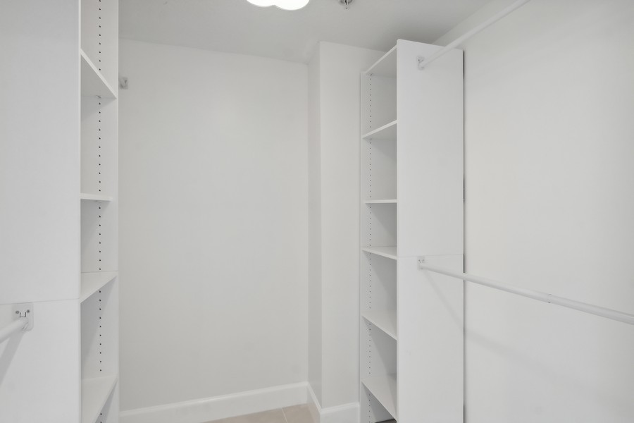 Real Estate Photography - 1551 N FLAGLER DRIVE UNIT 902, WEST PALM BEACH, FL, 33401 - Primary Bedroom Closet
