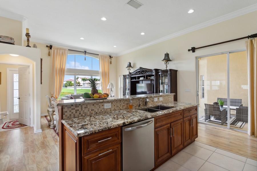 Real Estate Photography - 6159 Shadow Tree Ln, Lake Worth, FL, 33463 - Open Concept Kitchen; Natural Light & Recessed Lig