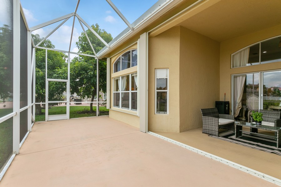 Real Estate Photography - 6159 Shadow Tree Ln, Lake Worth, FL, 33463 - Screen Enclosed Patio; Accordion Shutters