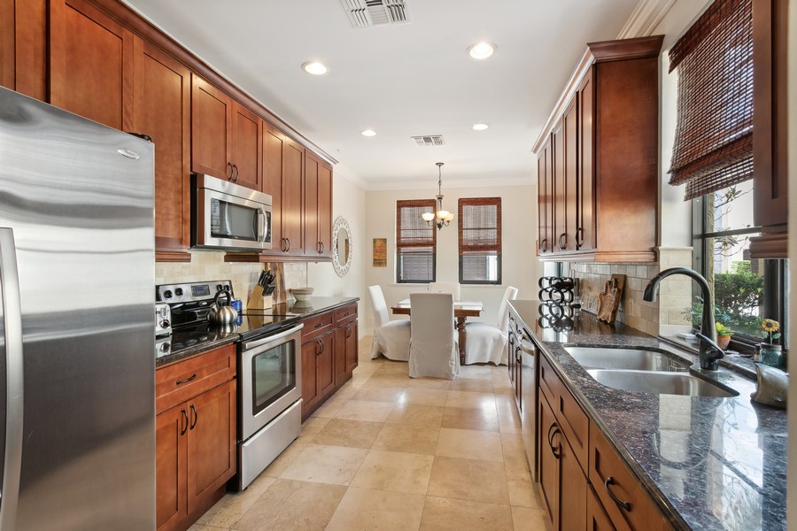Real Estate Photography - 310 Via Villagio, Hypoluxo, FL, 33462 - Galley Kitchen with Eat-in Breakfast