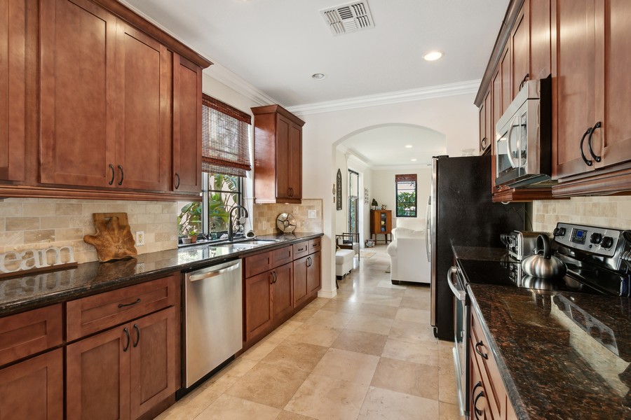Real Estate Photography - 310 Via Villagio, Hypoluxo, FL, 33462 - Mahogany wood cabinets, Granite, SS Appliances