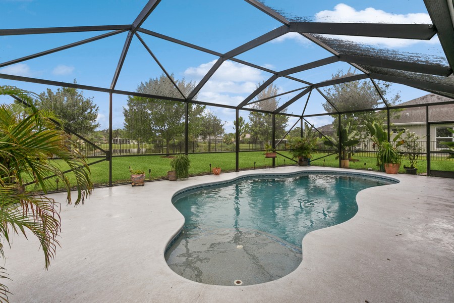 Real Estate Photography - 472 SW Vista Lake Drive, Port Saint Lucie, FL, 34953 - Free Form Pool in Screen Enclosed Patio